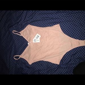 Light pink body suit size small never worn